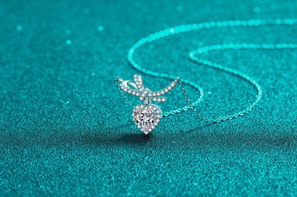 Bow and heart pendant, close up